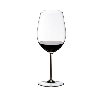 A red wine filled RIEDEL Sommeliers Bordeaux Grand Cru glass on white background