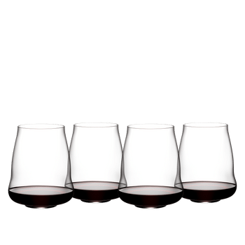 Four SL RIEDEL Stemless Wings Pinot Noir/Nebbiolo glasses filled with white wine on a white background.