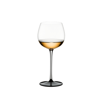 RIEDEL Sommeliers Black Tie Montrachet filled with a drink on a white background