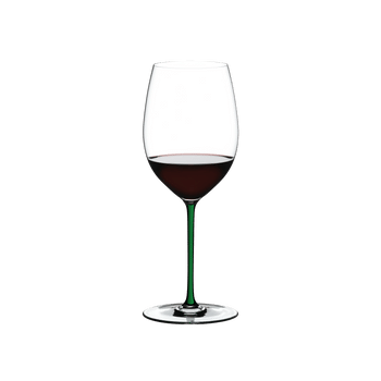 RIEDEL Fatto A Mano Cabernet/Merlot Green filled with a drink on a white background