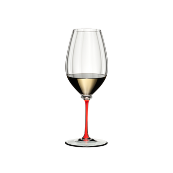 A RIEDEL Fatto A Mano Performance Riesling glass with red stem filled with white wine.