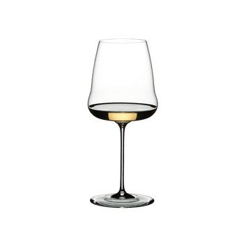 A RIEDEL Winewings Chardonnay glass filled with white wine on a white background.