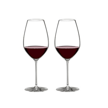 Two RIEDEL Veritas Cabernet Shiraz glasses filled with red wine stand side by side against a white background.