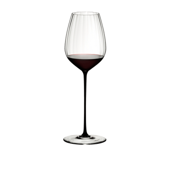 RIEDEL High Performance Cabernet Black filled with a drink on a white background