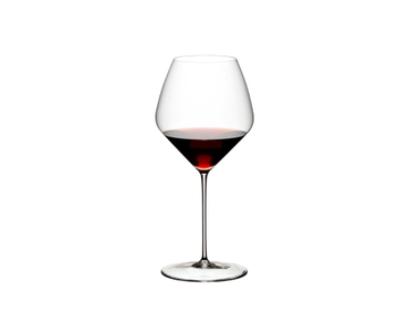 Two RIEDEL Veloce Pinot Noir/Nebbiolo glasses one filled with red wine and an unfilled glass on a white background.