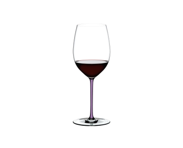 A RIEDEL Fatto A Mano Cabernet/Merlot glass in violet filled with red wine on a transparent background. 