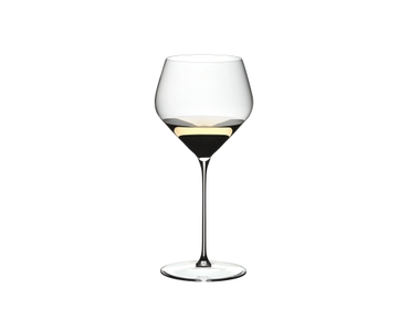 A RIEDEL Veloce Chardonnay glass filled with white wine on a white background.