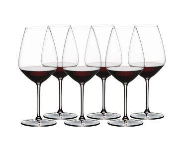 RIEDEL Extreme Shiraz filled with a drink on a white background