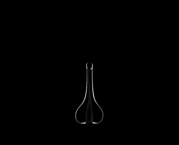 RIEDEL Decanter Black Tie Smile R.Q. filled with a drink on a black background