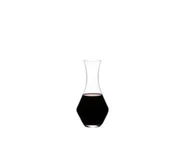RIEDEL Merlot Decanter filled with a drink on a white background