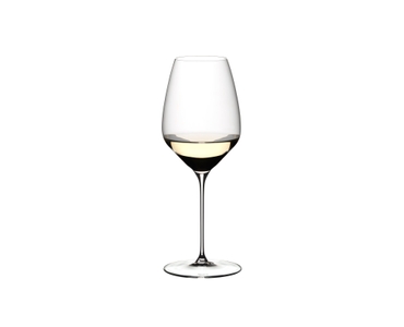 A RIEDEL Veloce Riesling glass filled with white wine on a white background.