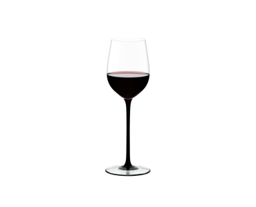 RIEDEL Sommeliers Black Tie Mature Bordeaux filled with a drink on a white background
