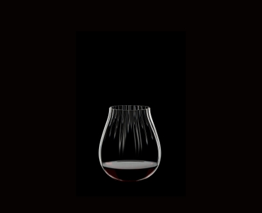 RIEDEL Tumbler Collection All Purpose Glass filled with a drink on a black background