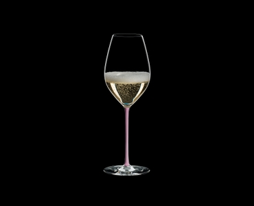 RIEDEL Fatto A Mano Champagne Wine Glass Pink R.Q. filled with a drink on a black background