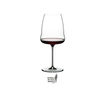 RIEDEL Winewings Syrah filled with a drink on a white background