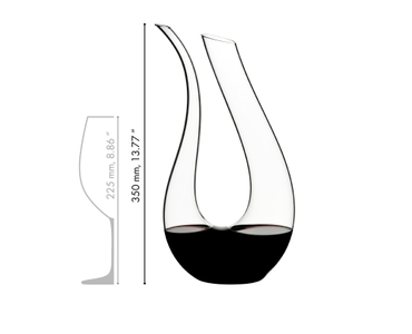 Red wine is being poured from a RIEDEL Amadeo Decanter into a RIEDEL Veritas Cabernet/Merlot glass