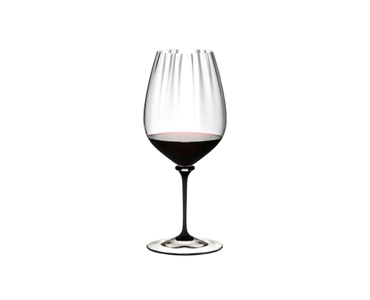 RIEDEL Fatto A Mano Performance Cabernet Black Stem filled with a drink on a white background