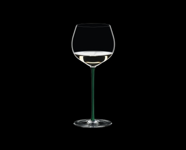RIEDEL Fatto A Mano Oaked Chardonnay Green R.Q. filled with a drink on a black background
