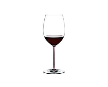 A RIEDEL Fatto A Mano Cabernet/Merlot glass in pink filled with red wine on a transparent background. 