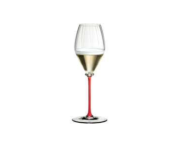A RIEDEL Fatto A Mano Performance Champagne Glass with a red stem and filled with champagne