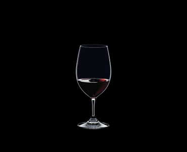RIEDEL Ouverture Magnum filled with a drink on a black background