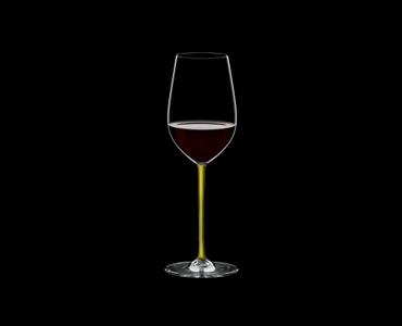 RIEDEL Fatto A Mano Riesling/Zinfandel Yellow R.Q. filled with a drink on a black background