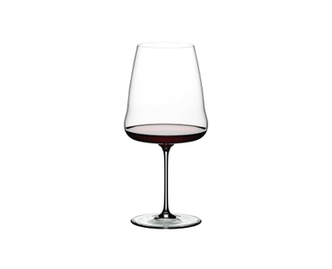 A RIEDEL Winewings Restaurant Cabernet/Merlot glass filled with red wine on a white background.
