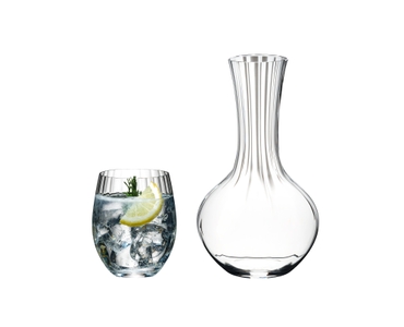 An unfilled RIEDEL Performance Decanter, a group of three unfilled Optical O Longdrink glasses and an Optical O Longdrink glass filled with a decorated Gin Tonic stand side by side on white background.