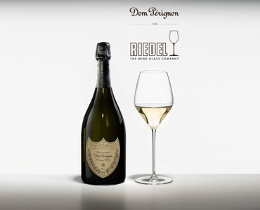 Dom Pérignon glass filled with Champagne on a white background