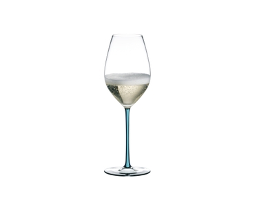 A RIEDEL Fatto A Mano Champagne Glass with a turquoise stem and filled with champagne.