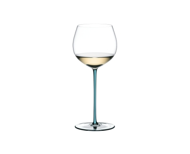 A RIEDEL Fatto A Mano Oaked Chardonnay glass in turquoise filled with white wine on a transparent background. 