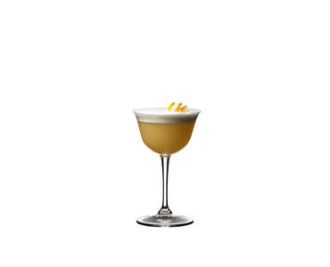 A RIEDEL Drink Specific Glassware Sour glass filled with Whisky Sour is standing on a black table in front of a background.
