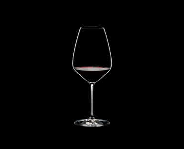 RIEDEL Extreme Restaurant Shiraz filled with a drink on a black background