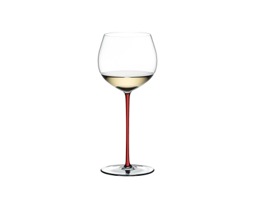 A RIEDEL Fatto A Mano Oaked Chardonnay with red stem filled with champagne on a white background.