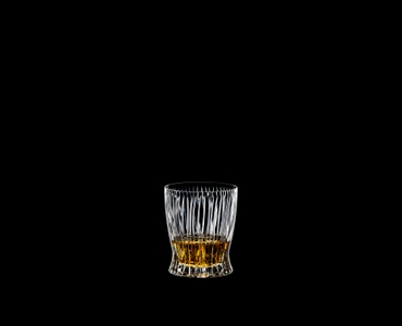 RIEDEL Tumbler Collection Fire Whisky filled with a drink on a black background