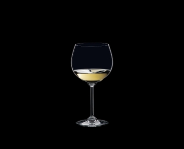 RIEDEL Wine Oaked Chardonnay filled with a drink on a black background