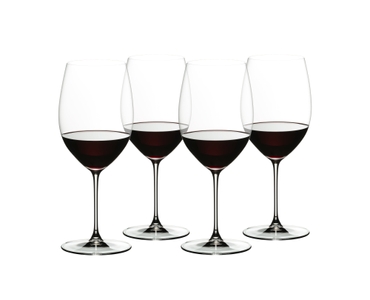 4 red wine filled RIEDEL Veritas Cabernet/Merlot glasses stand slightly offset next to each other on white background