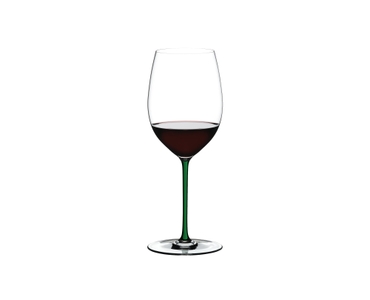 A RIEDEL Fatto A Mano Cabernet/Merlot in green filled with red wine on a transparent background. 