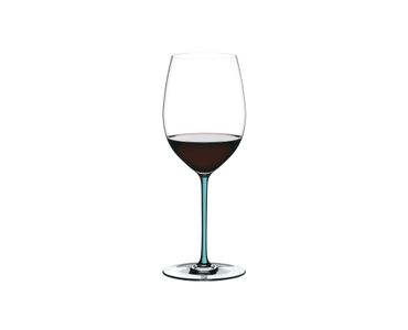 A RIEDEL Fatto A Mano Cabernet/Merlot glass in turquoise filled with red wine on a transparent background. 