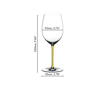 A RIEDEL Fatto A Mano Cabernet/Merlot glass in yellow filled with red wine on a white background. 