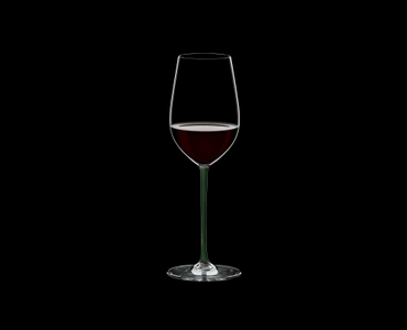 RIEDEL Fatto A Mano Riesling/Zinfandel Green filled with a drink on a black background