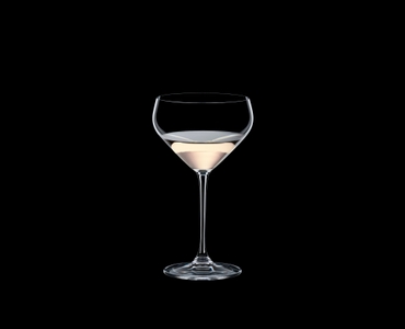 RIEDEL Extreme Junmai filled with a drink on a black background