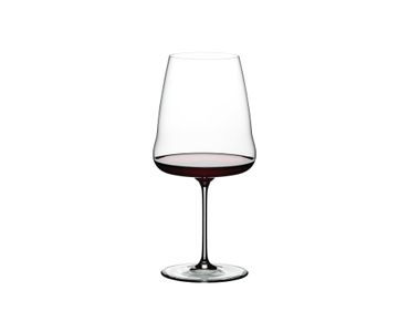 A RIEDEL Winewings Cabernet/Merlot glass filled with red wine on a white background.