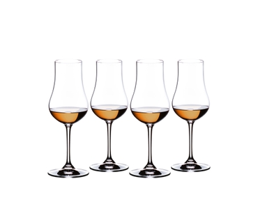 Four RIEDEL Rum glasses filled with rum side by side.