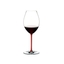A RIEDEL Fatto A Mano Syrah glass in red filled with red wine on a transparent background. 
