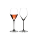 Two RIEDEL Extreme Rosé Wine / Rosé Champagne Glasses. One is unfilled, the other one is filled with Rosé Champagne.
