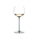 A RIEDEL Fatto A Mano Oaked Chardonnay with a mint colored stem and filled with white wine.
