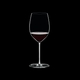 RIEDEL Fatto A Mano Cabernet/Merlot White R.Q. filled with a drink on a black background