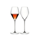 Two RIEDEL Veloce Rose glasses one filled with rose wine and an unfilled glass on a white background.