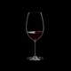 RIEDEL Veritas Restaurant New World Shiraz filled with a drink on a black background